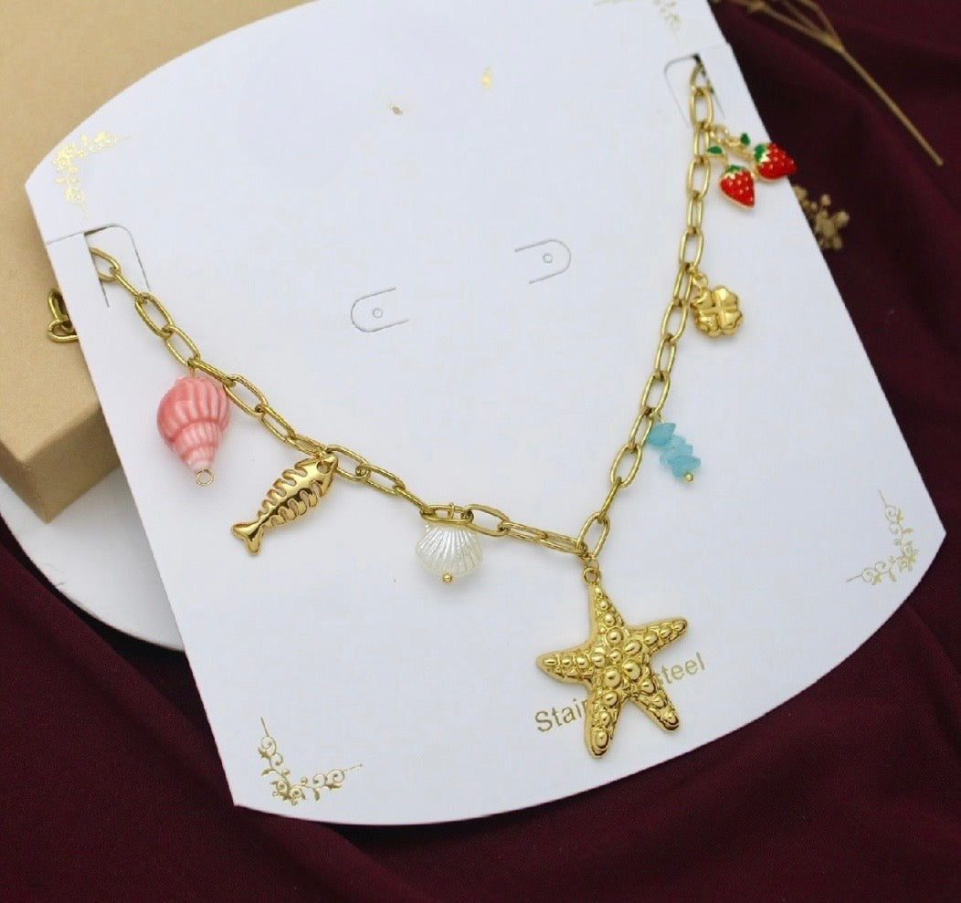 Stainless steel charm necklace with assorted charms including a starfish, shell, fish, strawberries, and four-leaf clover