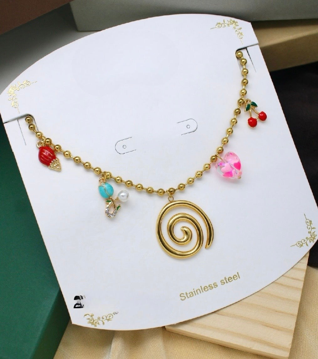 Stainless steel charm necklace featuring a swirl pendant, cherries, a heart, and other decorative elements